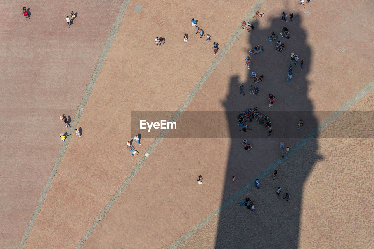 High angle view of people on town square in city during sunny day