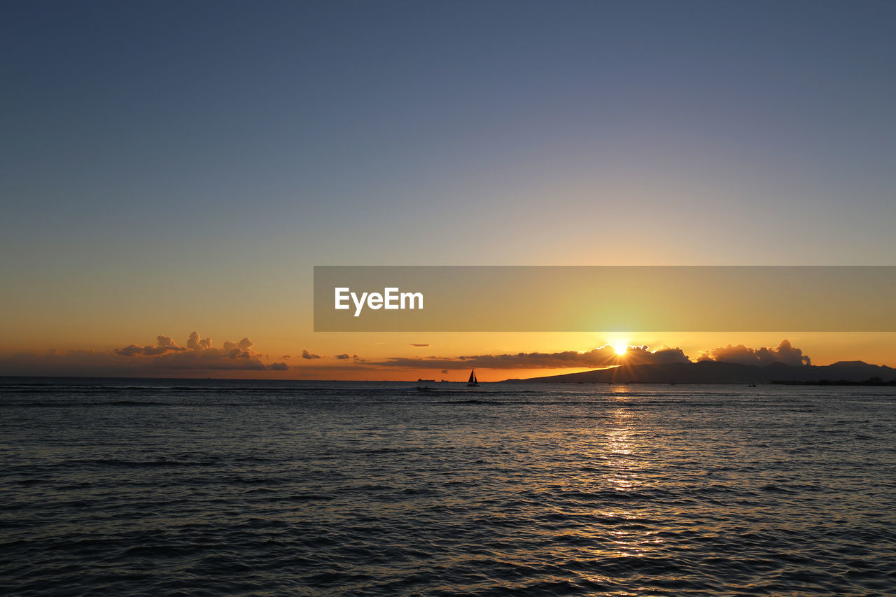 Scenic view of sea against clear sky during sunset