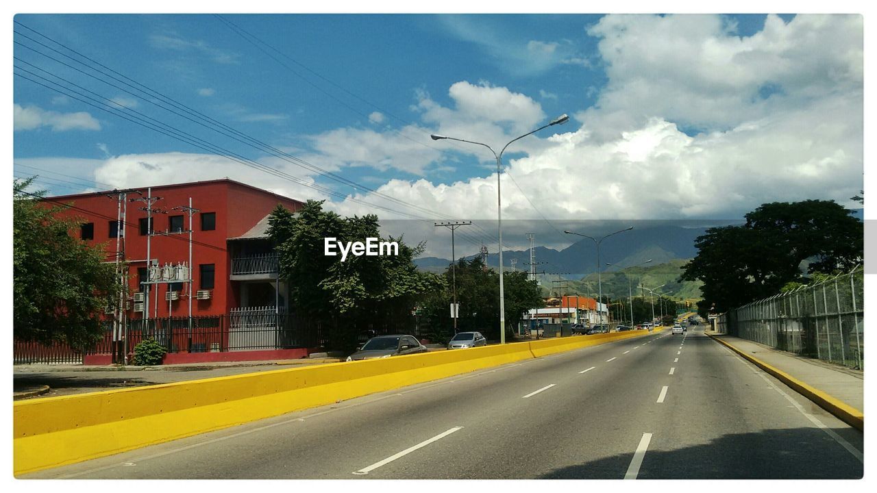 VIEW OF ROAD AGAINST CLOUDY SKY