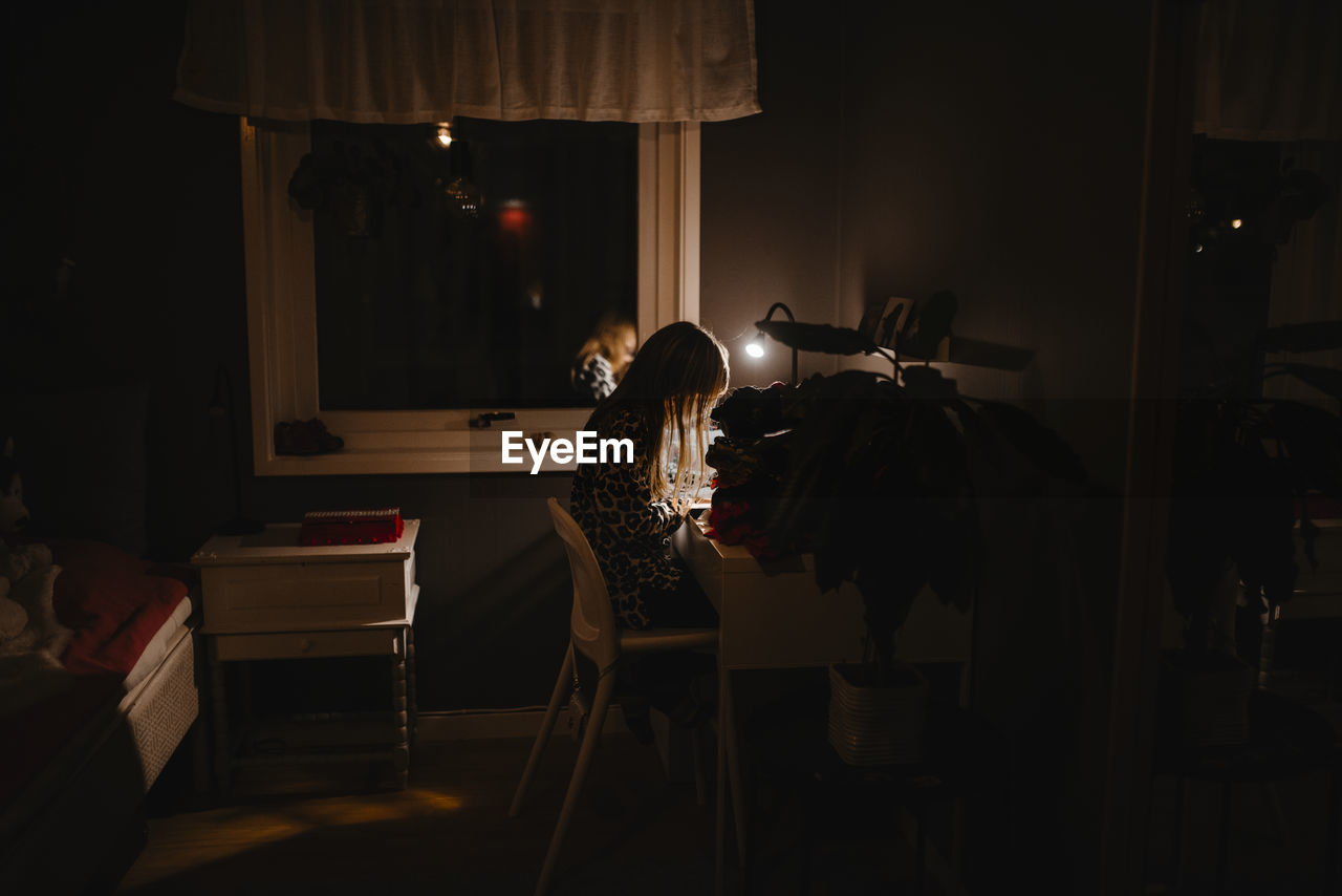 Girl at night sitting at desk