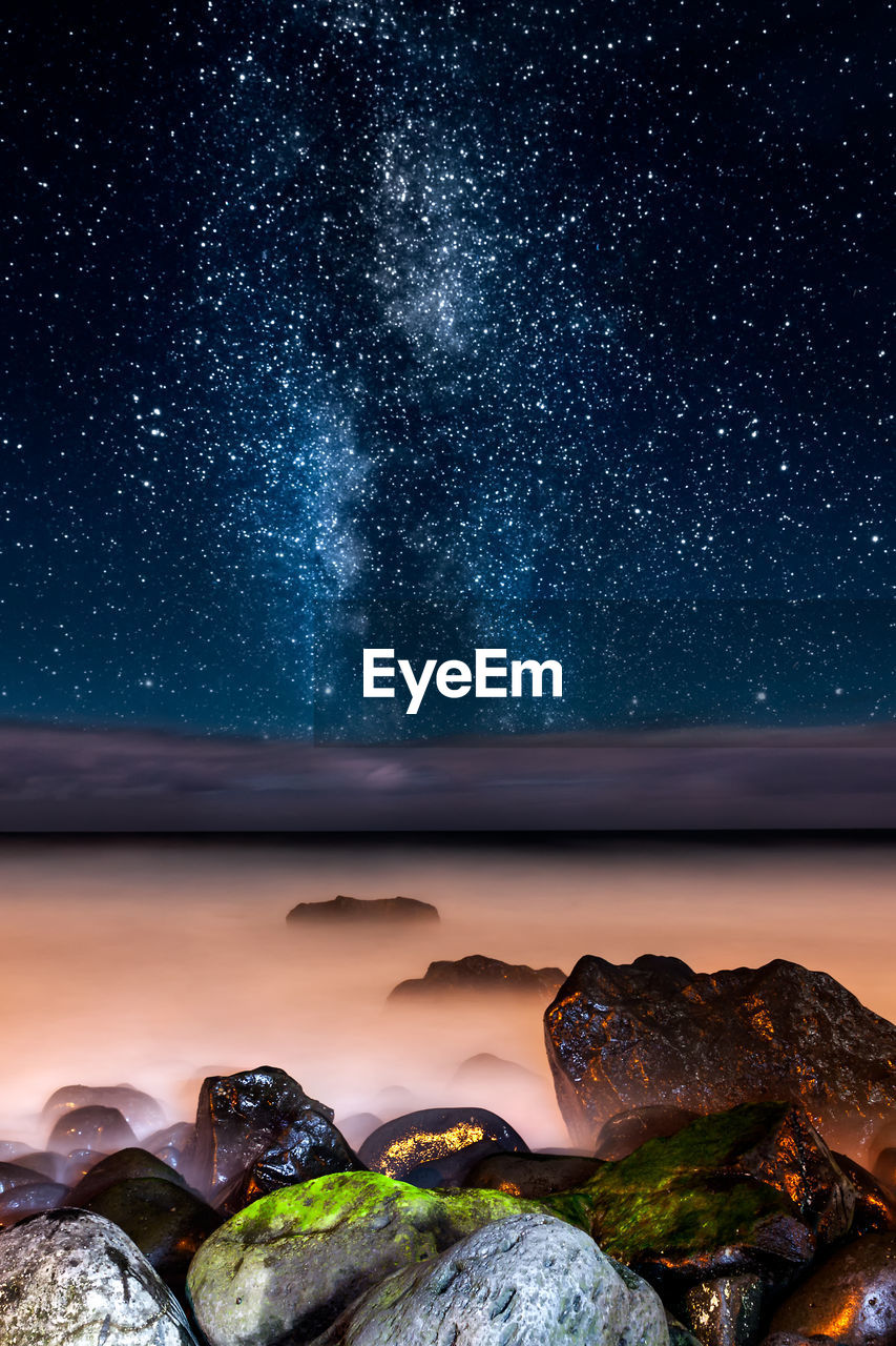 Scenic view of sea against clear sky at night