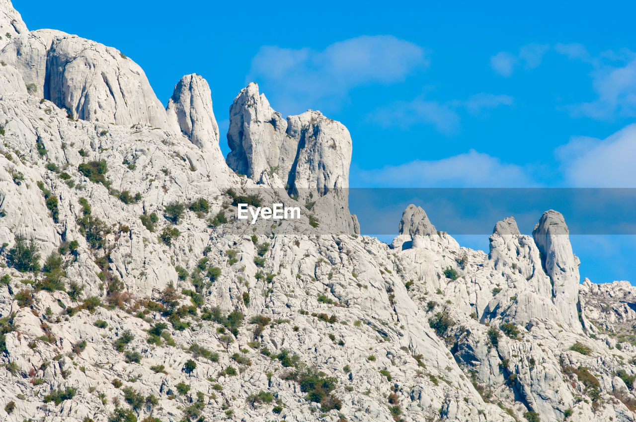 Low angle view of rock against sky