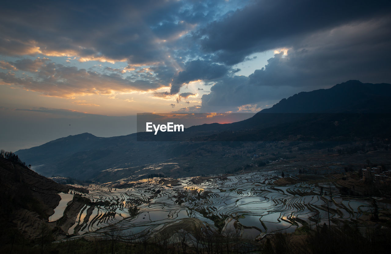 Scenic view of mountains against sky during sunset