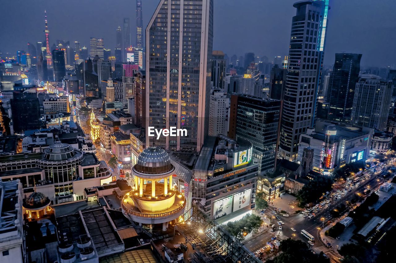 High angle view of illuminated buildings in city at night