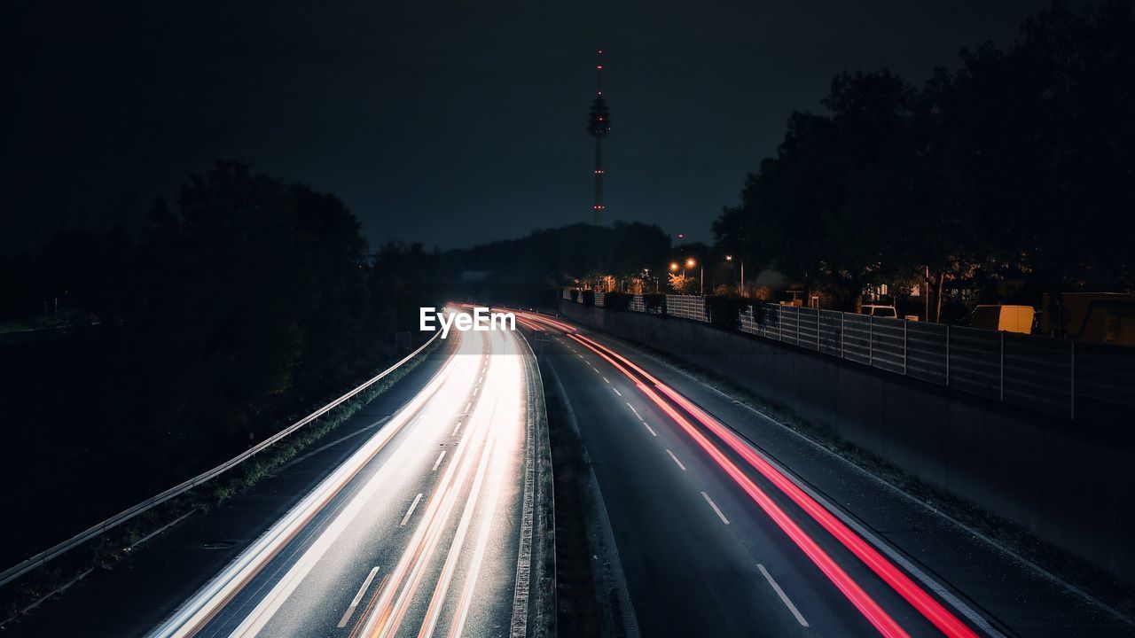 Light trails on road in city at night