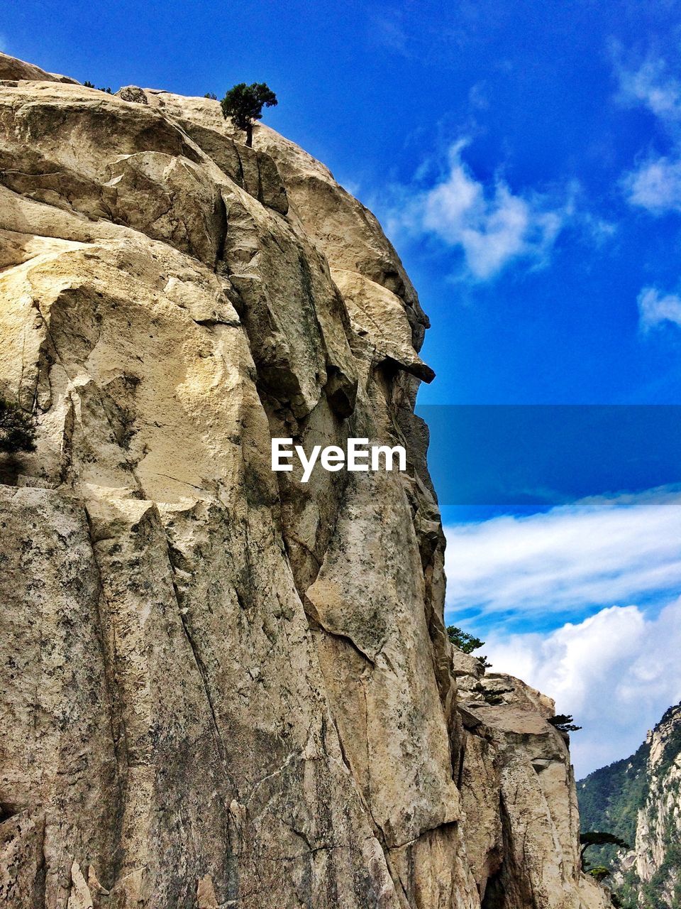 LOW ANGLE VIEW OF ROCKS AGAINST BLUE SKY