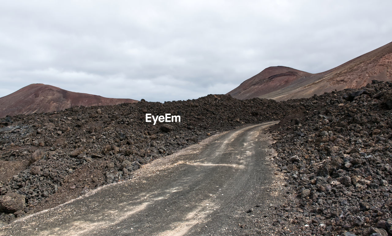 A road built between the solidified lava of a volcano. lanzarote. canary islands, spain