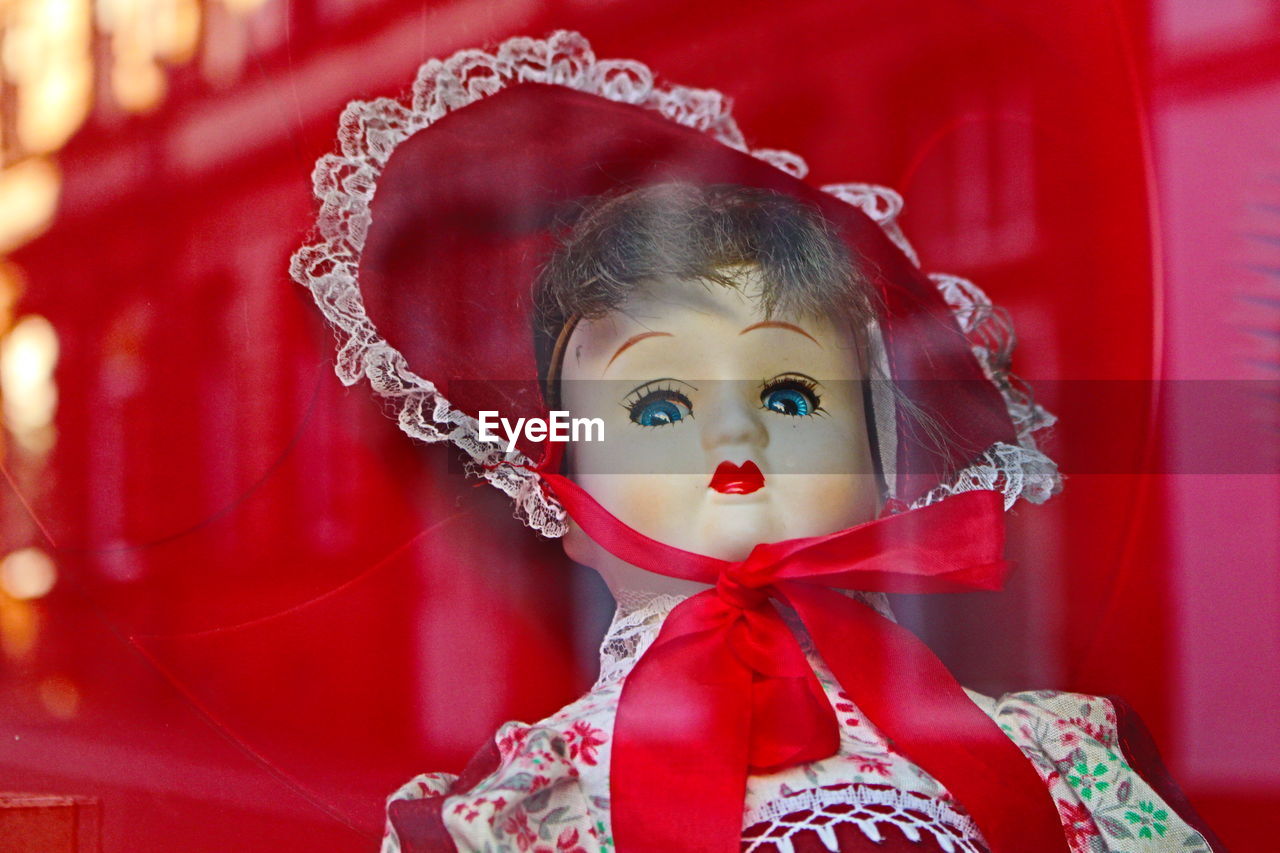 Doll seen through glass