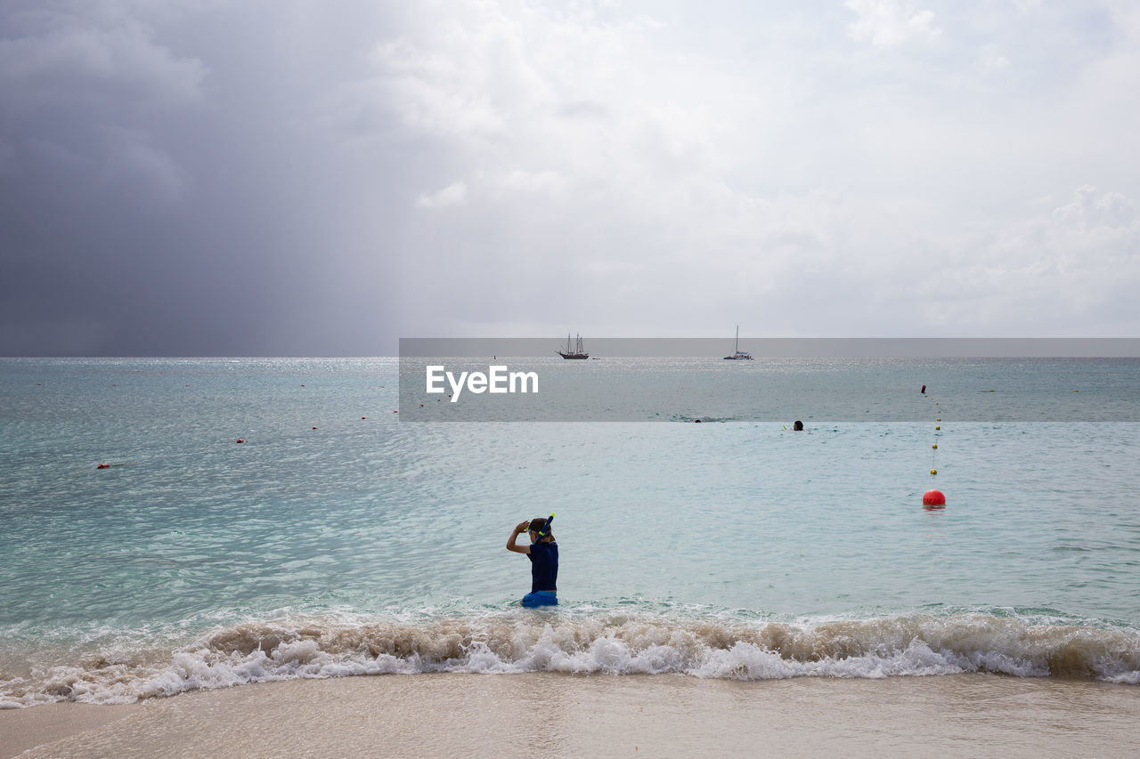 Rear view of boy at beach