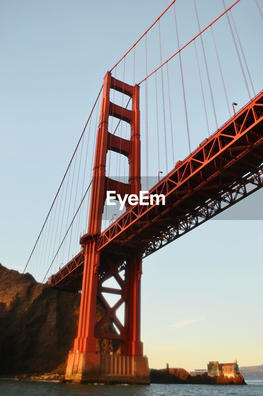 Low angle view of golden gate bridge over river against sky