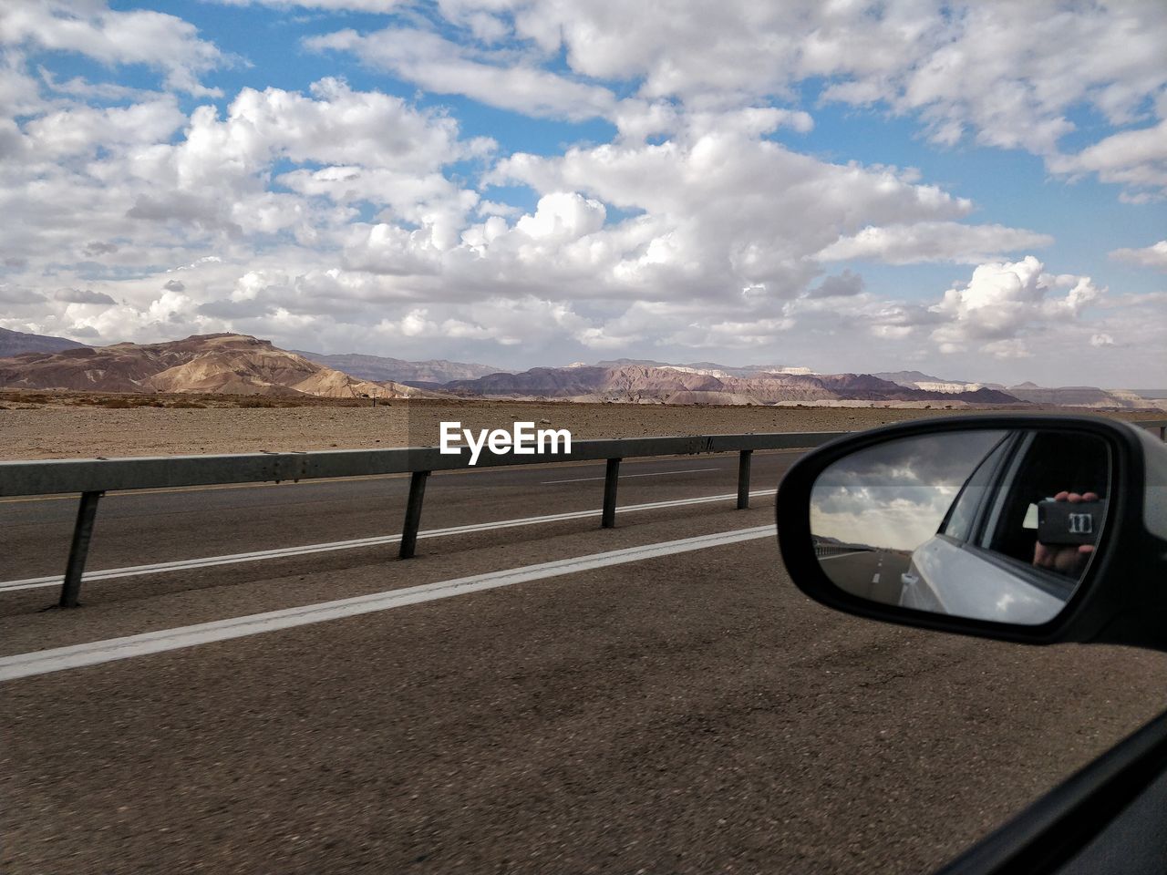 VIEW OF SIDE-VIEW MIRROR AGAINST SKY