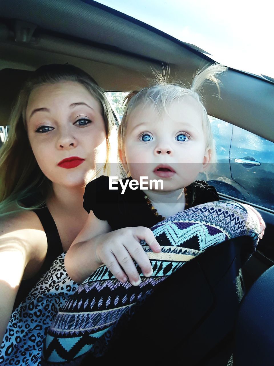 PORTRAIT OF FRIENDS SITTING IN CAR