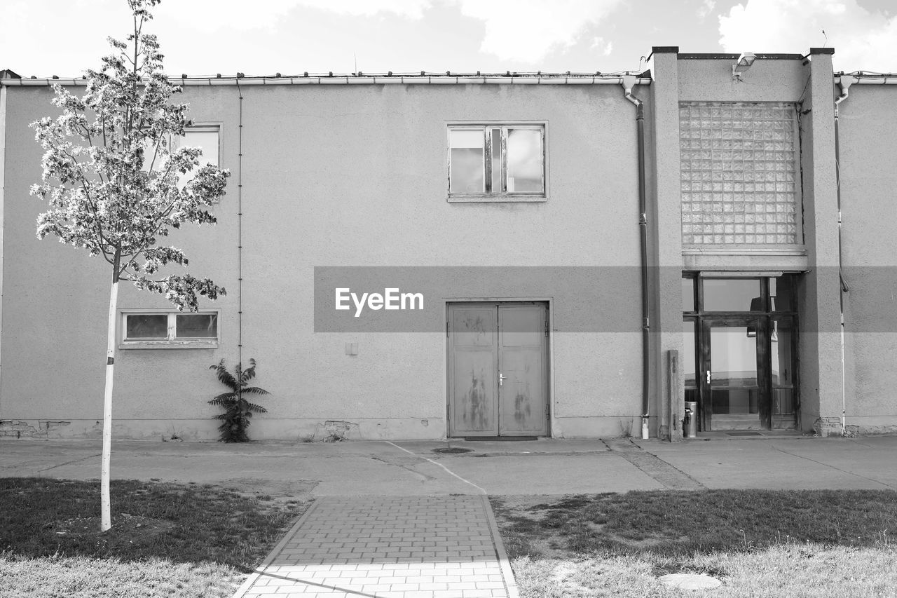 EXTERIOR OF BUILDING BY STREET AGAINST SKY