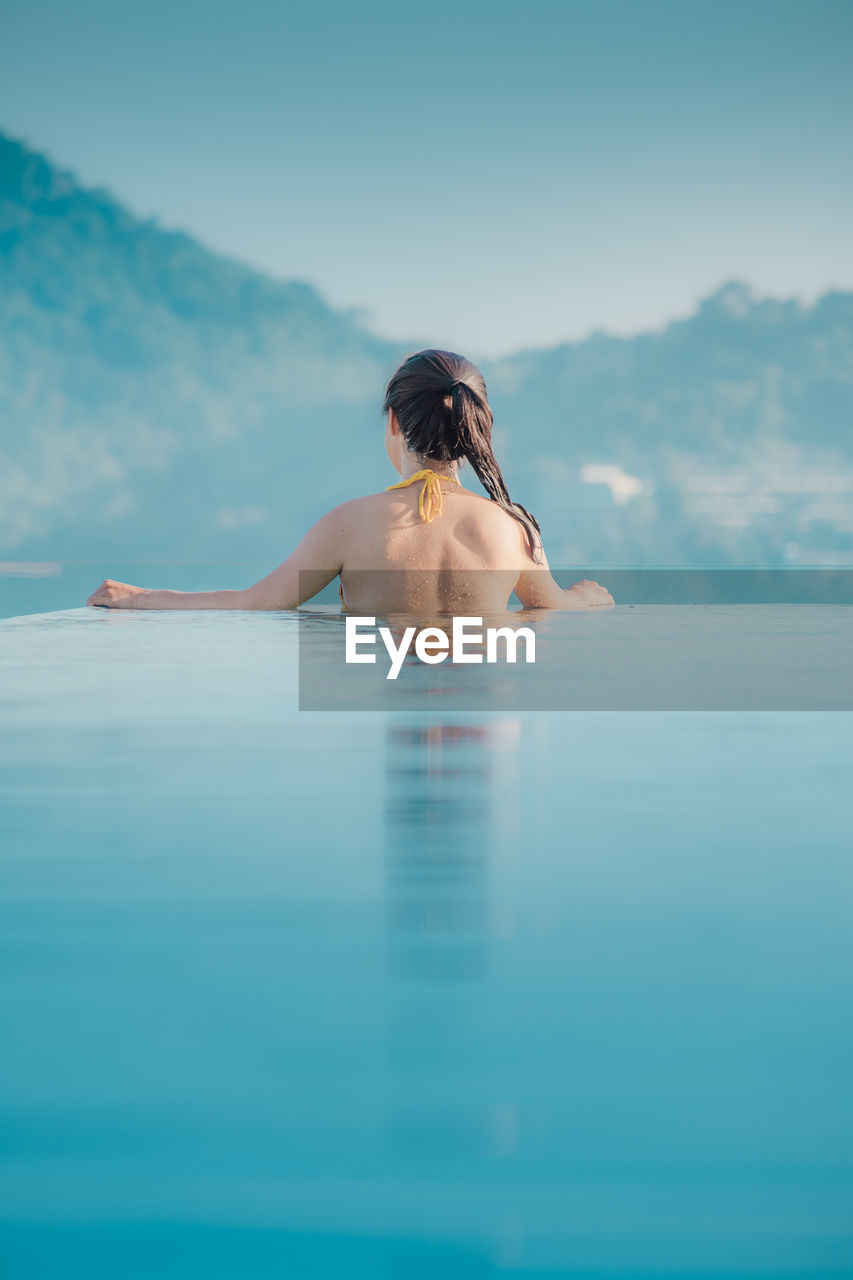 Full length of woman swimming in sea against sky