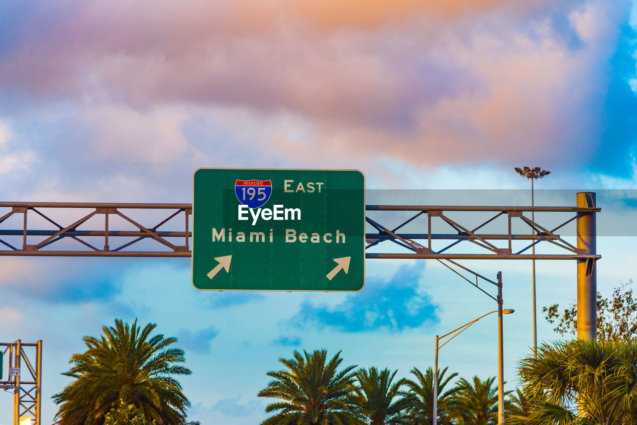 LOW ANGLE VIEW OF SIGNBOARD AGAINST SKY