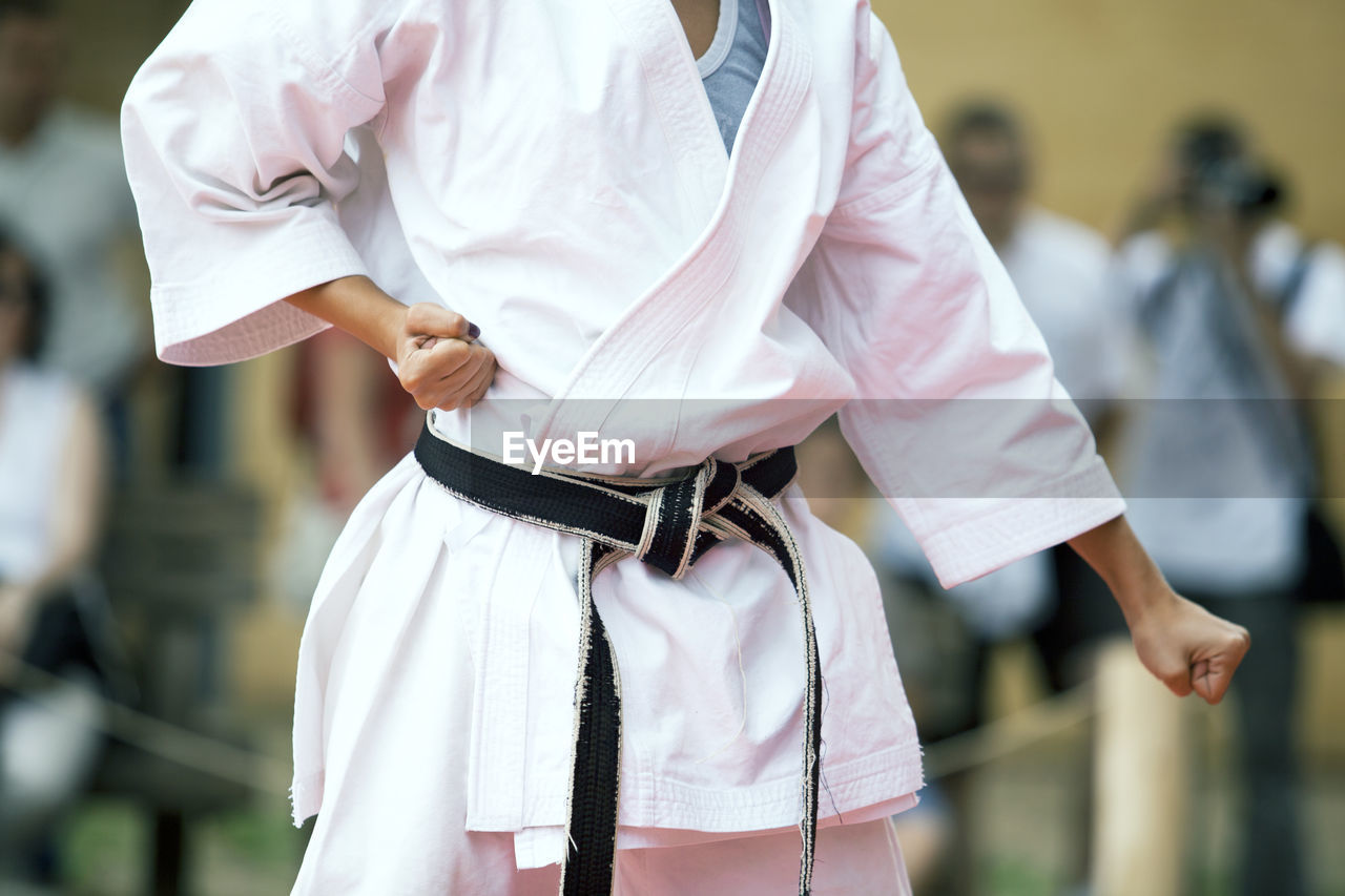 Midsection of woman practicing karate
