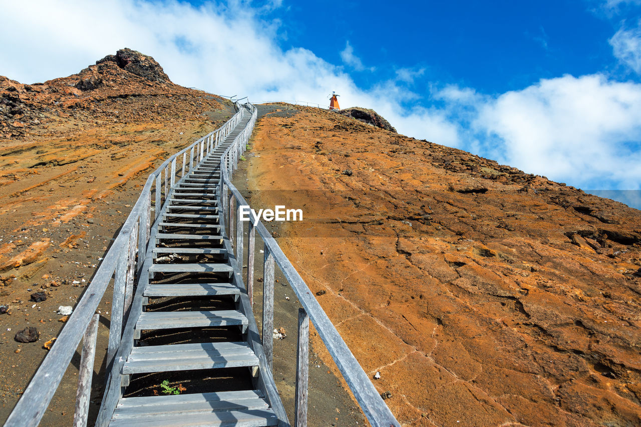 Low angle view of steps on mountain against sky at bartolome island