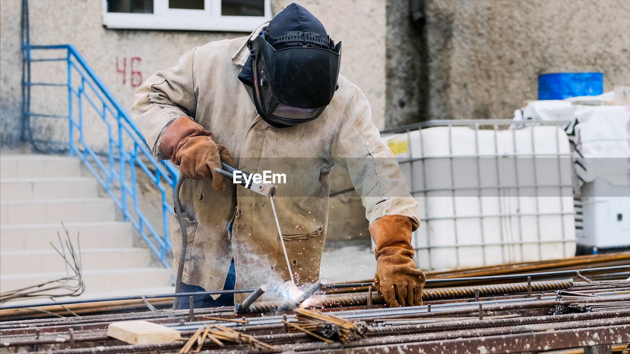 MAN WORKING ON METAL