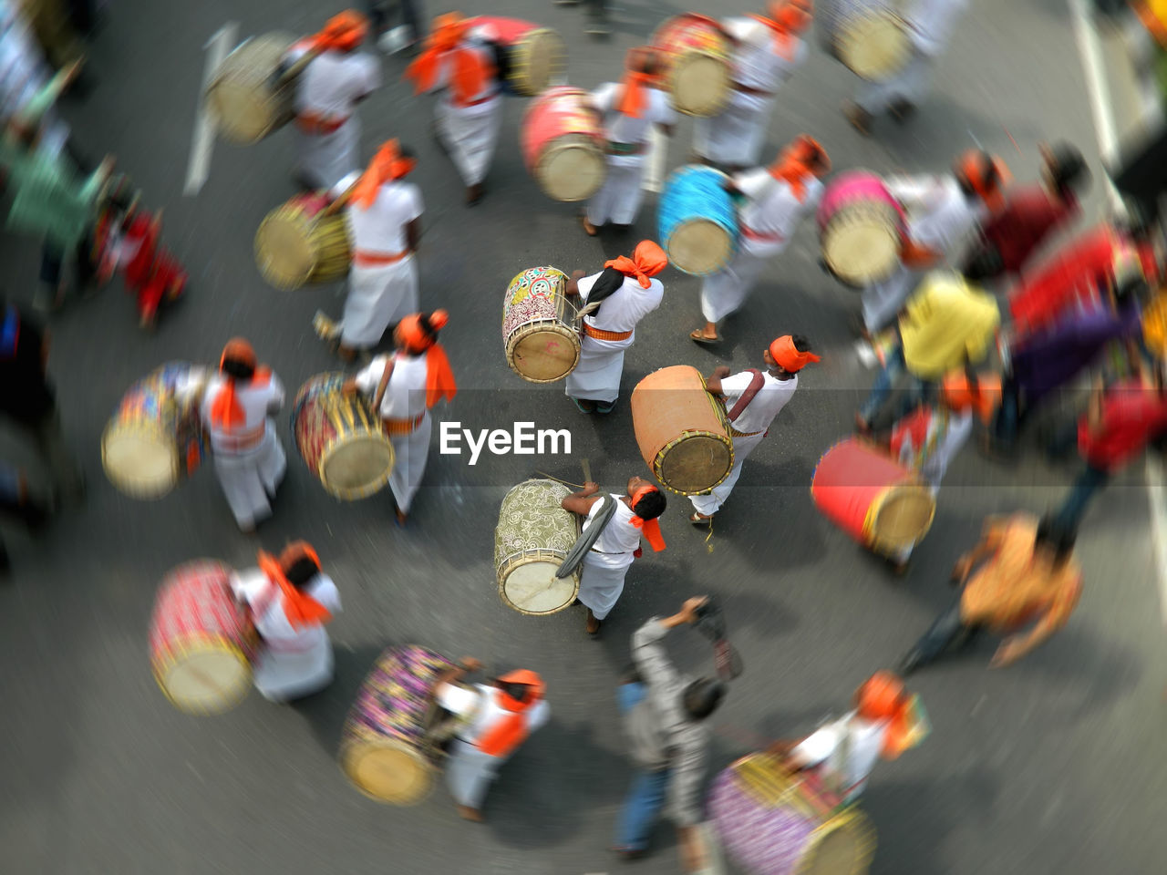 High angle view of men with drums walking on street