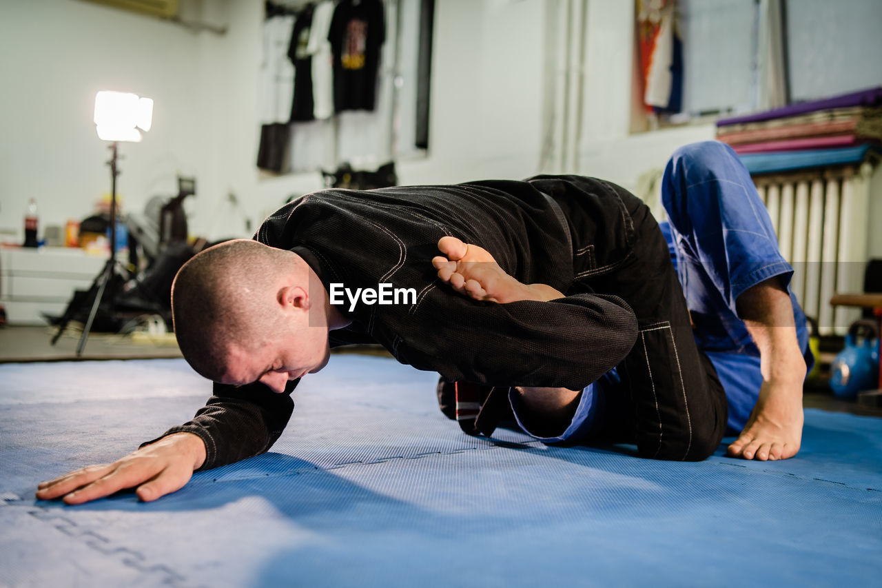 MAN LYING DOWN ON FLOOR