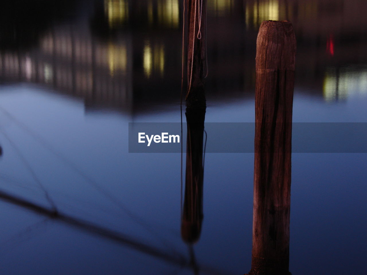 Close-up of wooden poles in water
