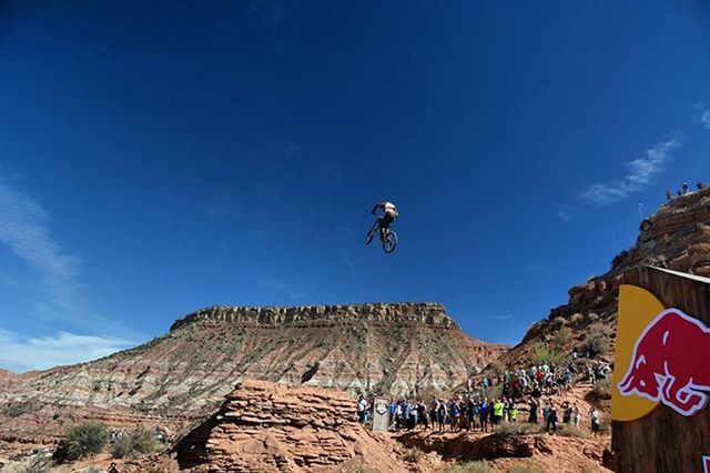 LOW ANGLE VIEW OF PERSON STANDING ON ROCK FORMATION