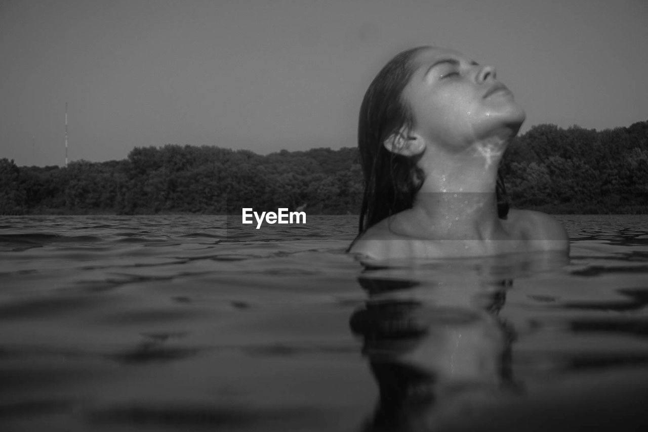 Woman swimming in lake