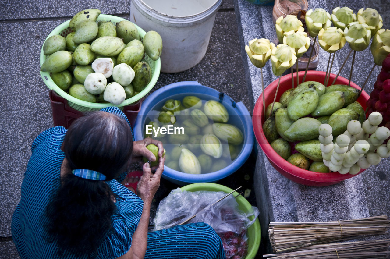 High angle view of woman selling fruits at market