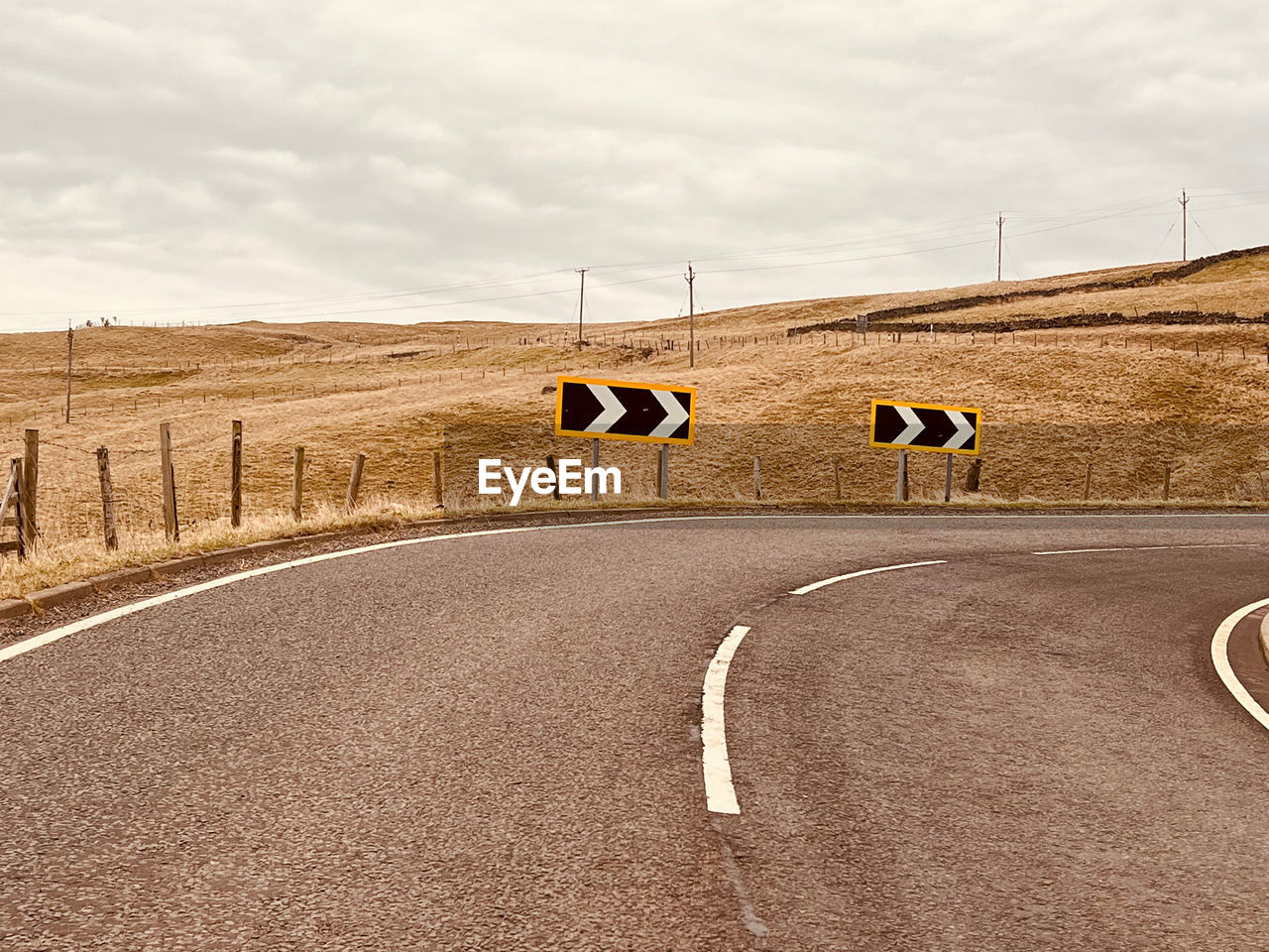 road, transportation, sky, sign, cloud, nature, landscape, environment, symbol, no people, road marking, asphalt, sand, land, day, marking, architecture, road sign, outdoors, travel, street, infrastructure, highway, city, rural scene, tarmac, soil, built structure