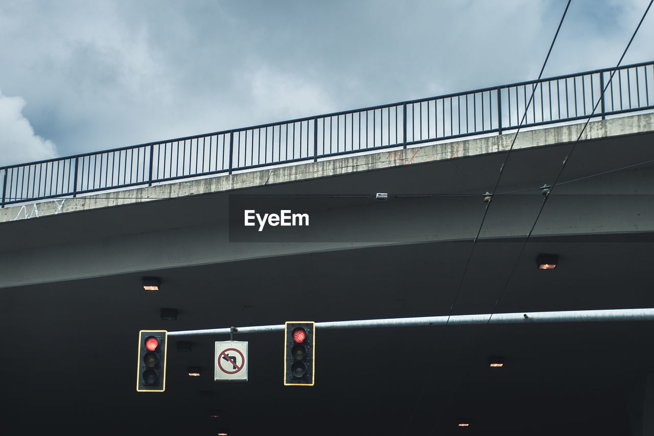 Low angle view of signal against bridge