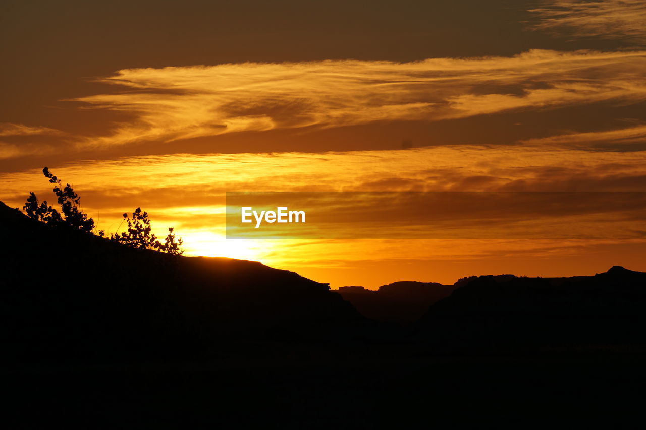 SILHOUETTE LANDSCAPE AGAINST ORANGE SKY