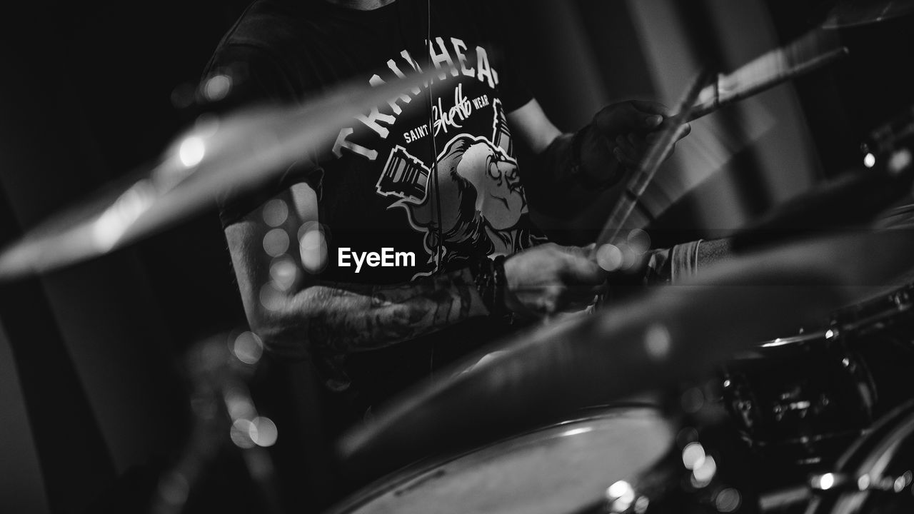 Close-up of man playing drums