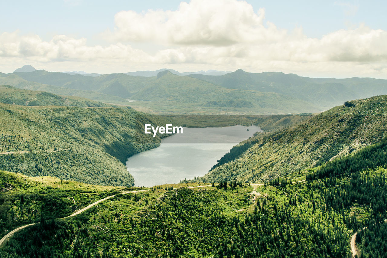 Scenic view of greenery at cascade range against sky