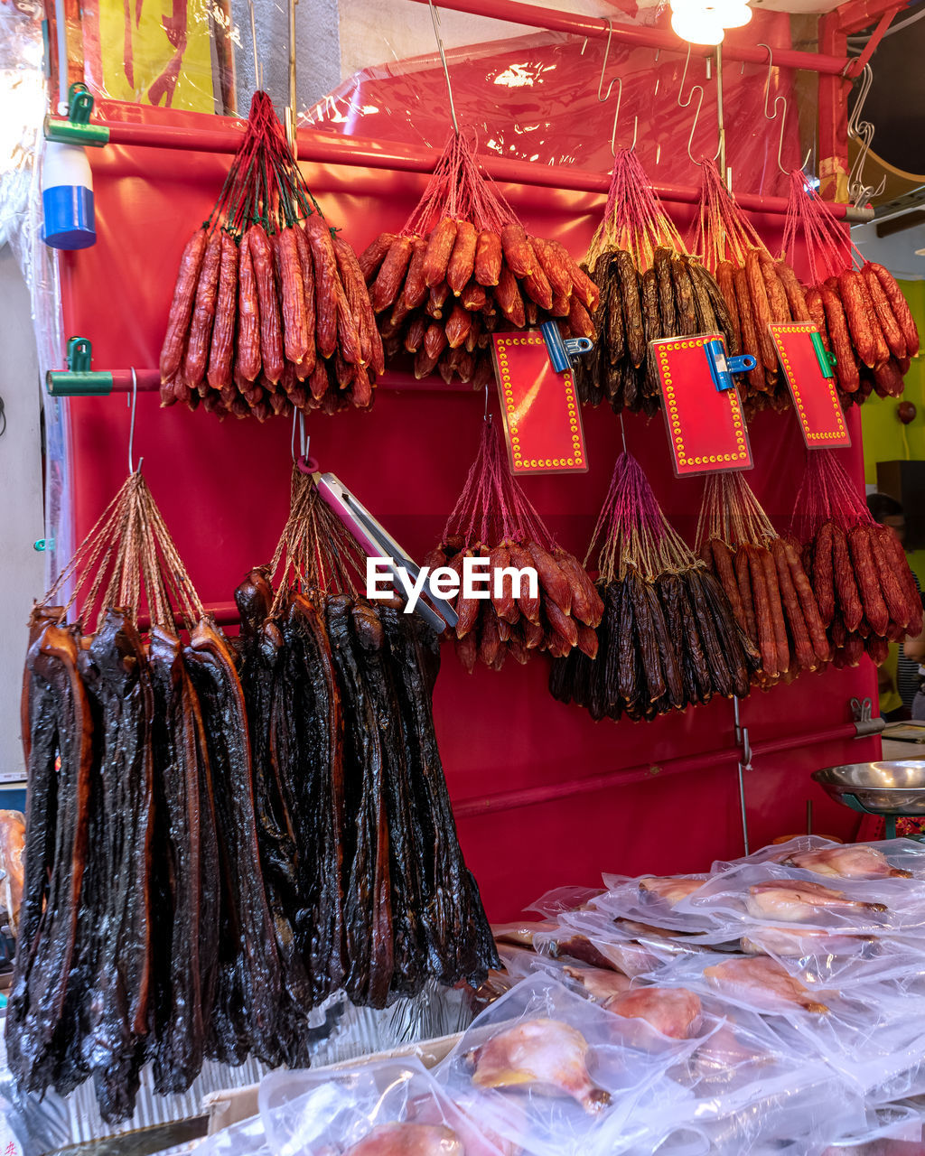 Hanging dried sausages and meat products in a butcher shop display. singapore, chinatown