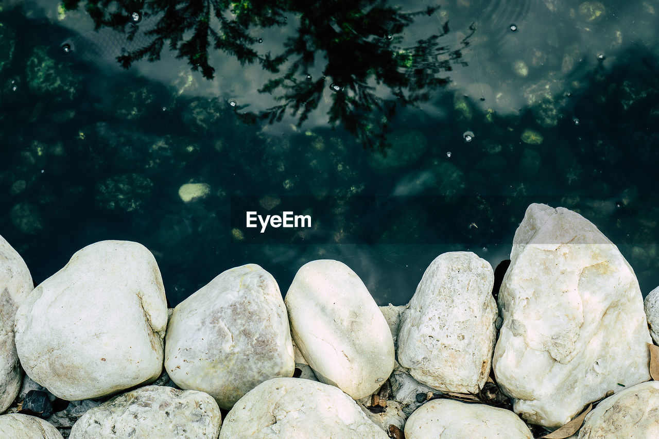 Close-up of stones in shallow water