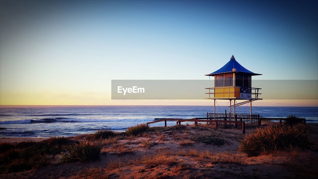 View of calm beach at sunset