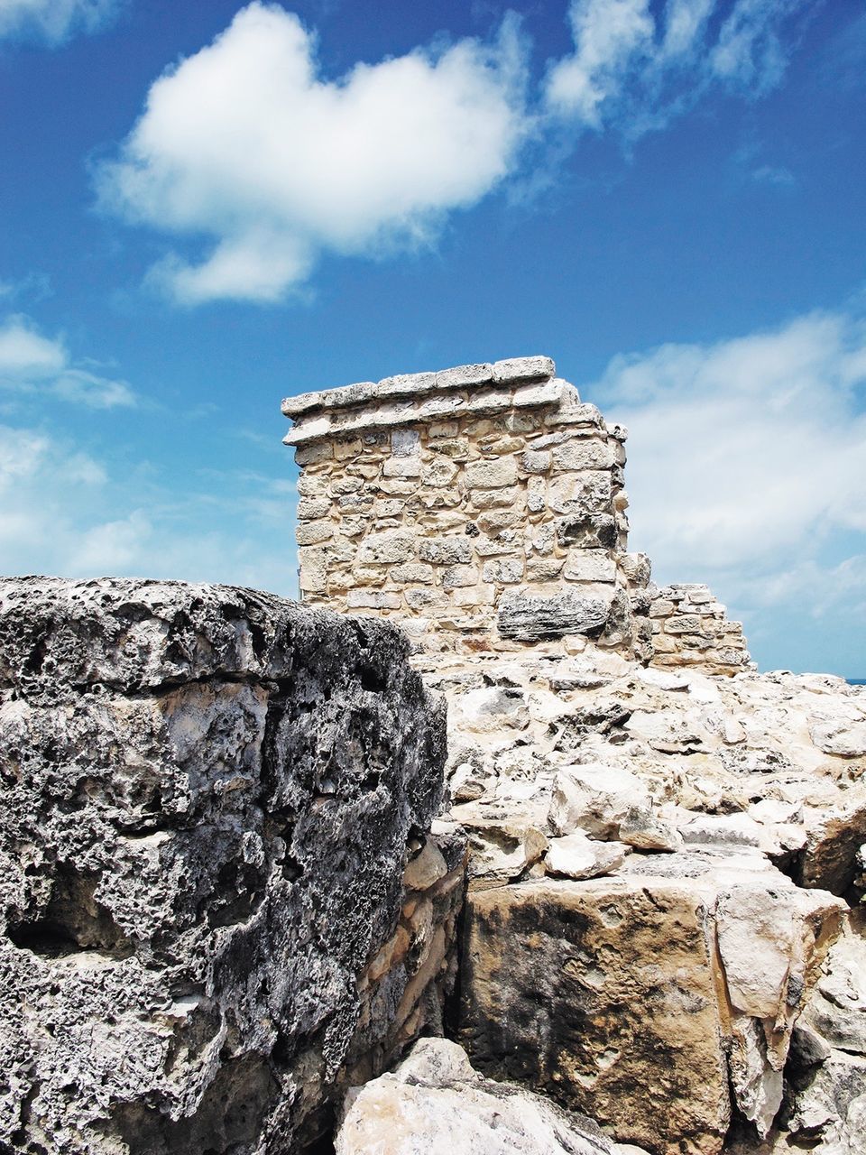 LOW ANGLE VIEW OF OLD BUILT STRUCTURE AGAINST BLUE SKY