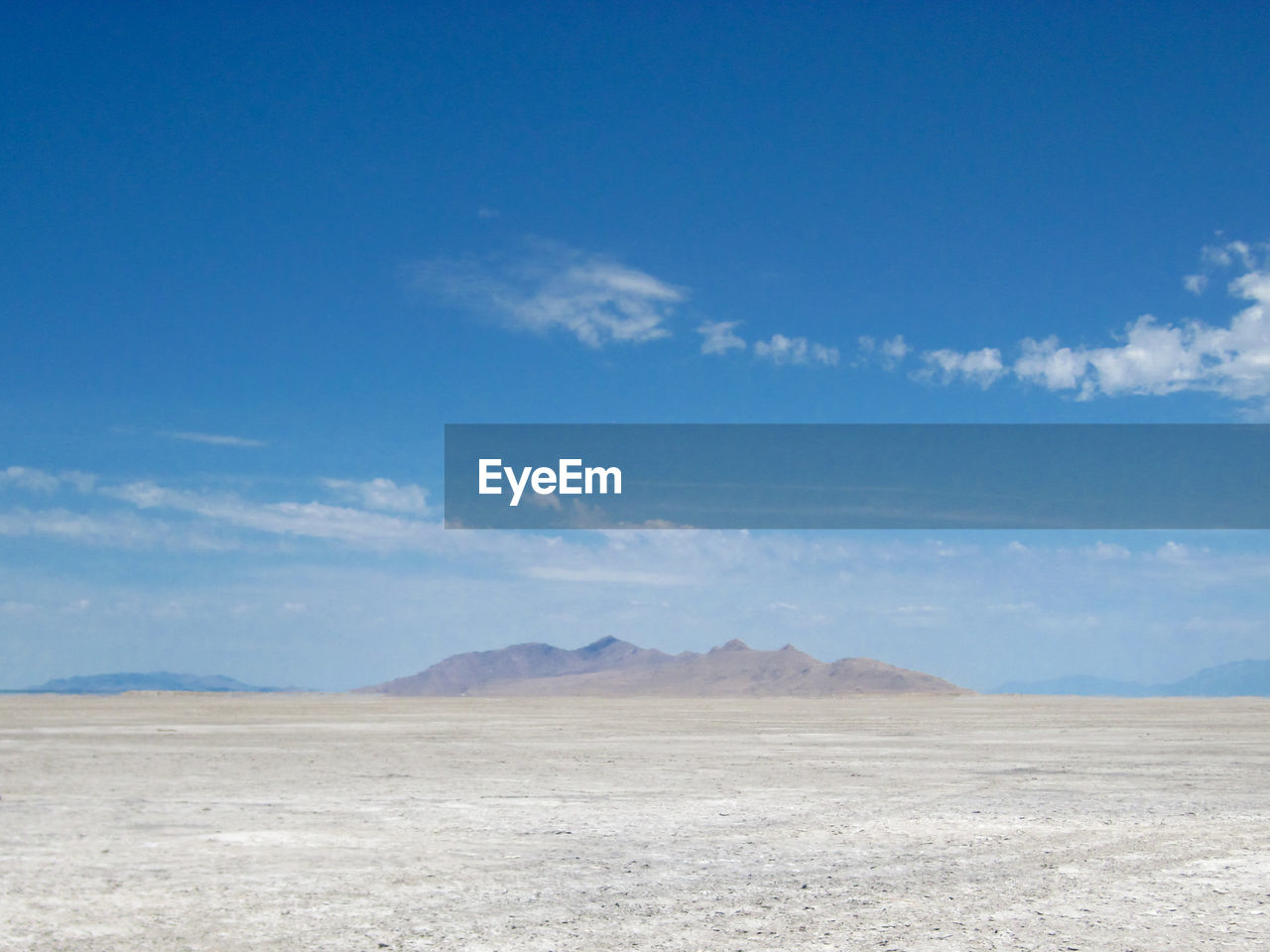 Scenic view of mountains against blue sky