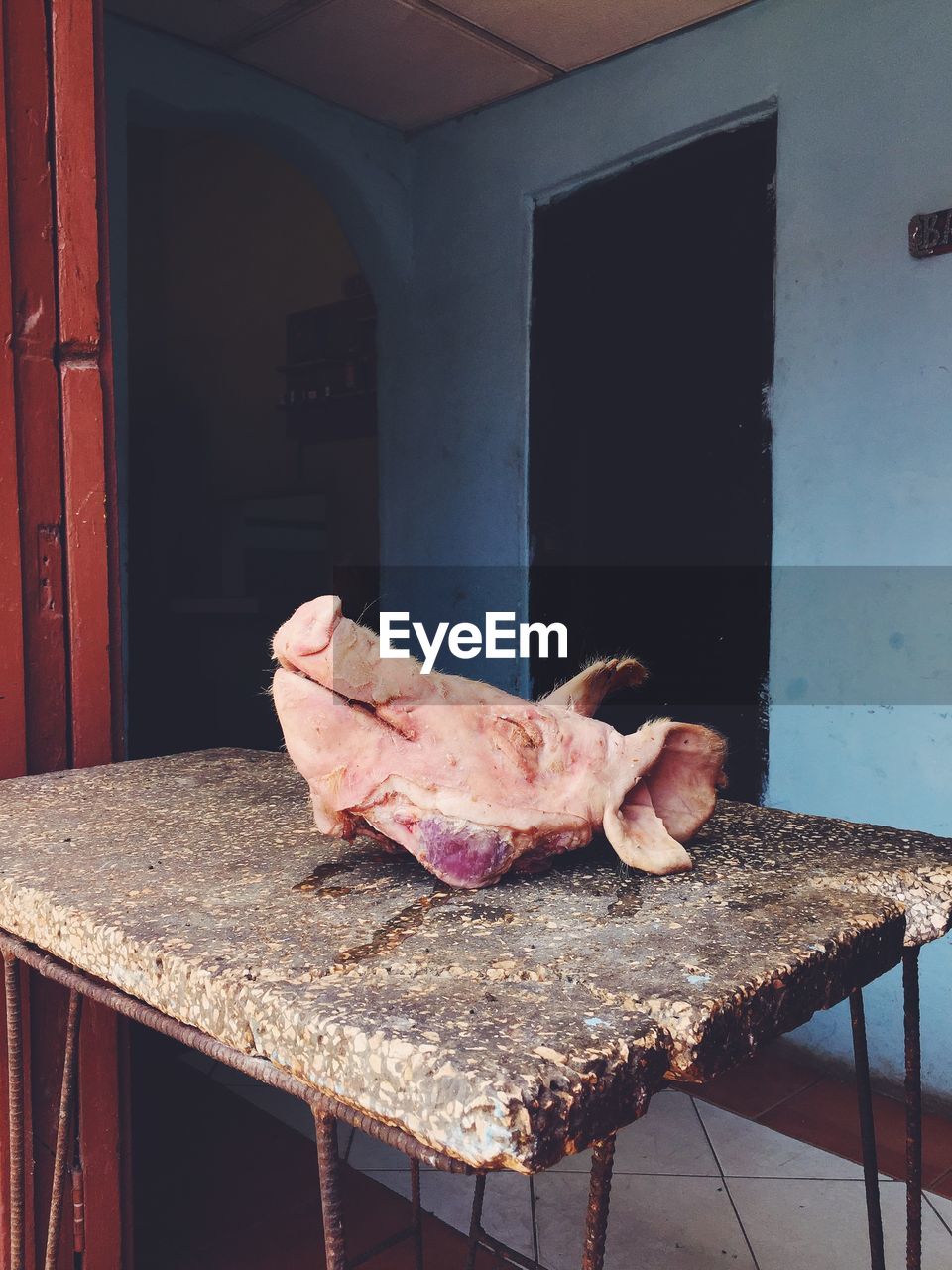 Close-up of pig head on table at shop