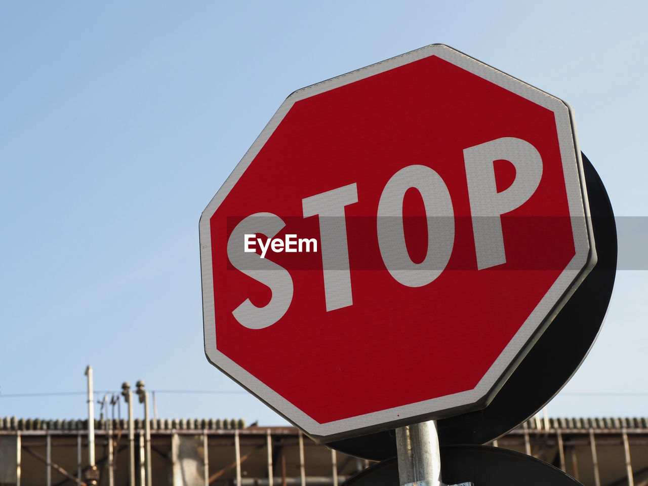 stop sign, road sign, sign, communication, road, red, signage, sky, traffic sign, text, transportation, western script, warning sign, guidance, nature, advertising, stop - single word, clear sky, no people, day, outdoors, information sign, street sign, city
