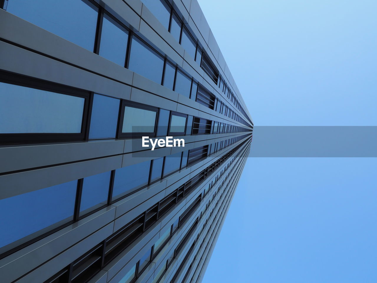 LOW ANGLE VIEW OF SKYSCRAPERS AGAINST CLEAR BLUE SKY