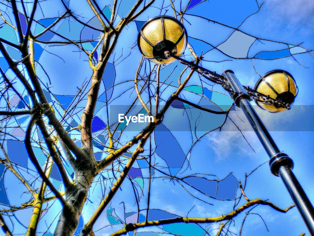 LOW ANGLE VIEW OF LAMP POST AGAINST BLUE SKY