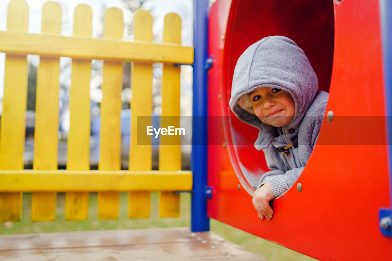 PORTRAIT OF CUTE BOY WITH RED HAT