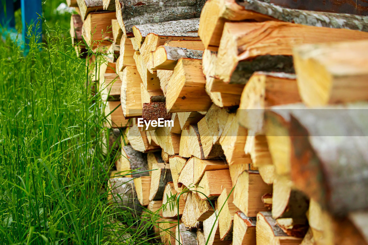 Stack of chopped firewood. eco-friendly bio fuel. woodpile near village house. rural life.
