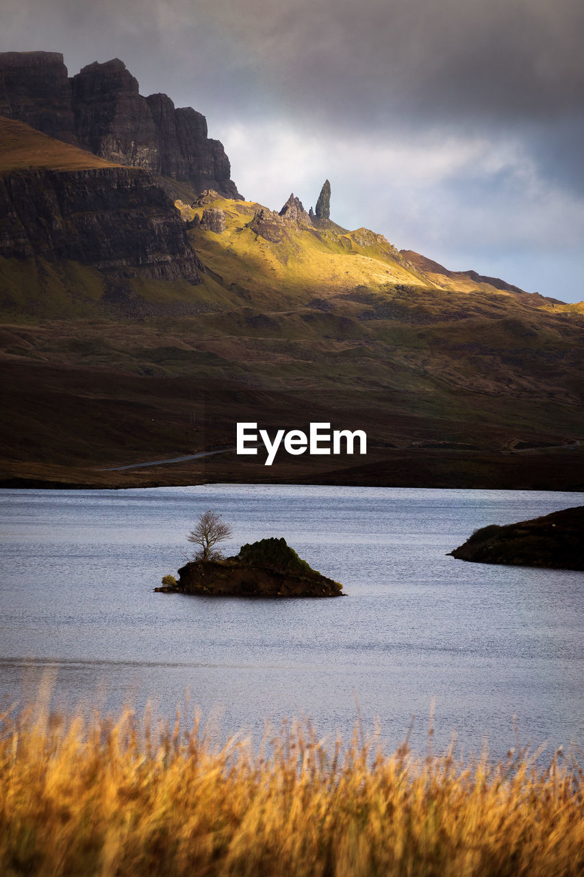 Scenic view of lake and mountains against sky