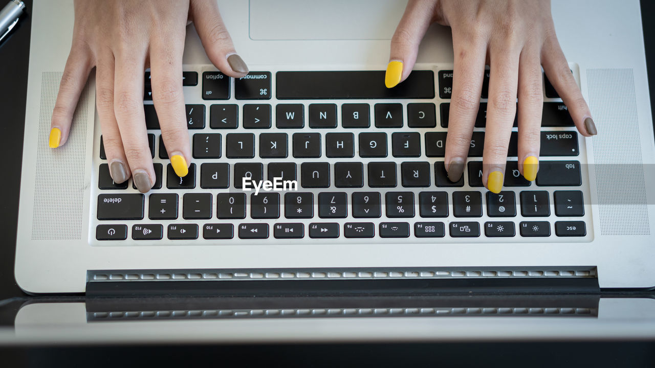 LOW SECTION OF MAN USING LAPTOP