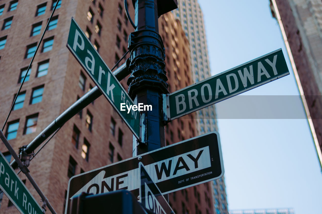 Low angle view of road signs against building