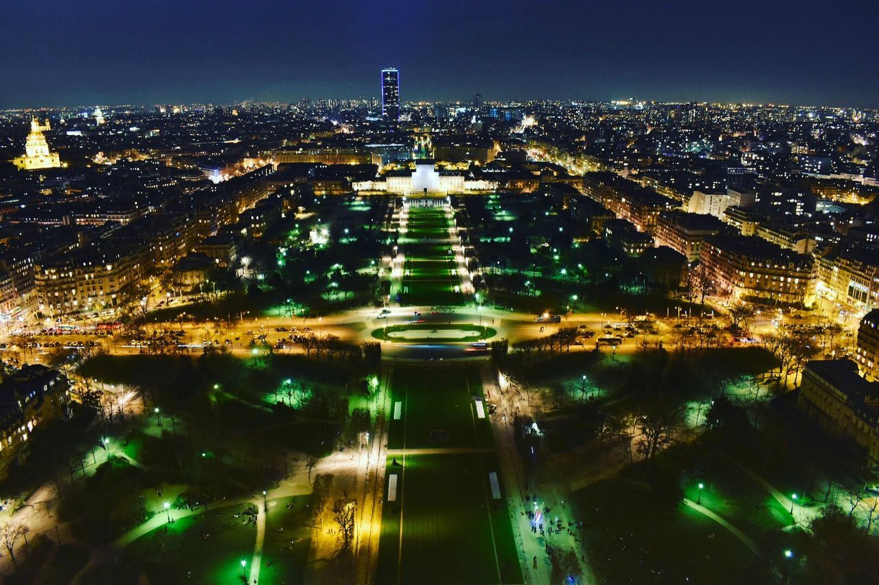 Aerial view of city lit up at night