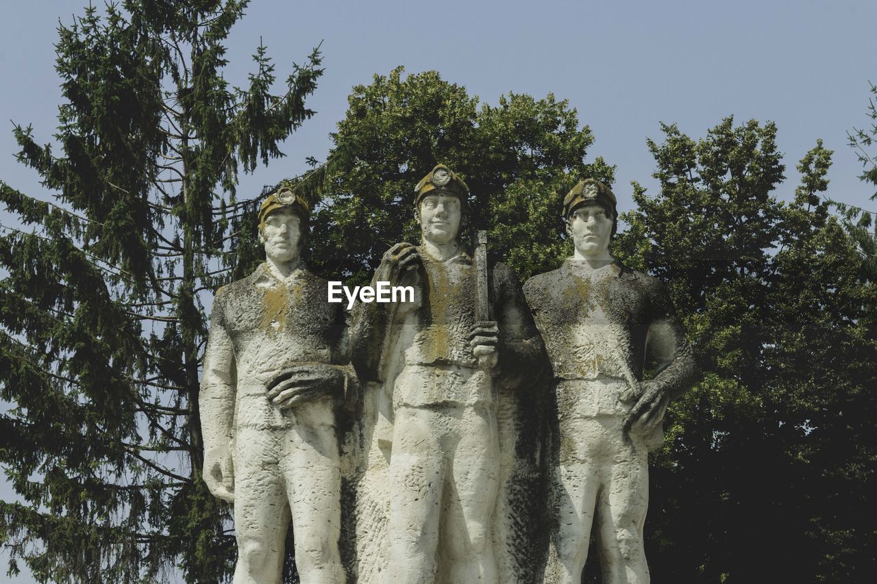 Low angle view of statue against trees