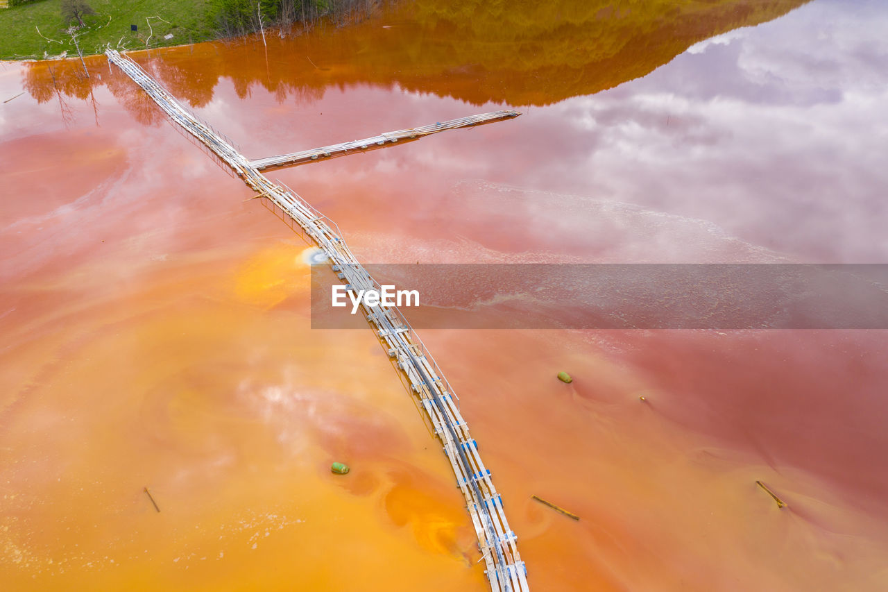 Aerial view of mining settling basin and lime supply. colorful polluted mine water geamana, romania